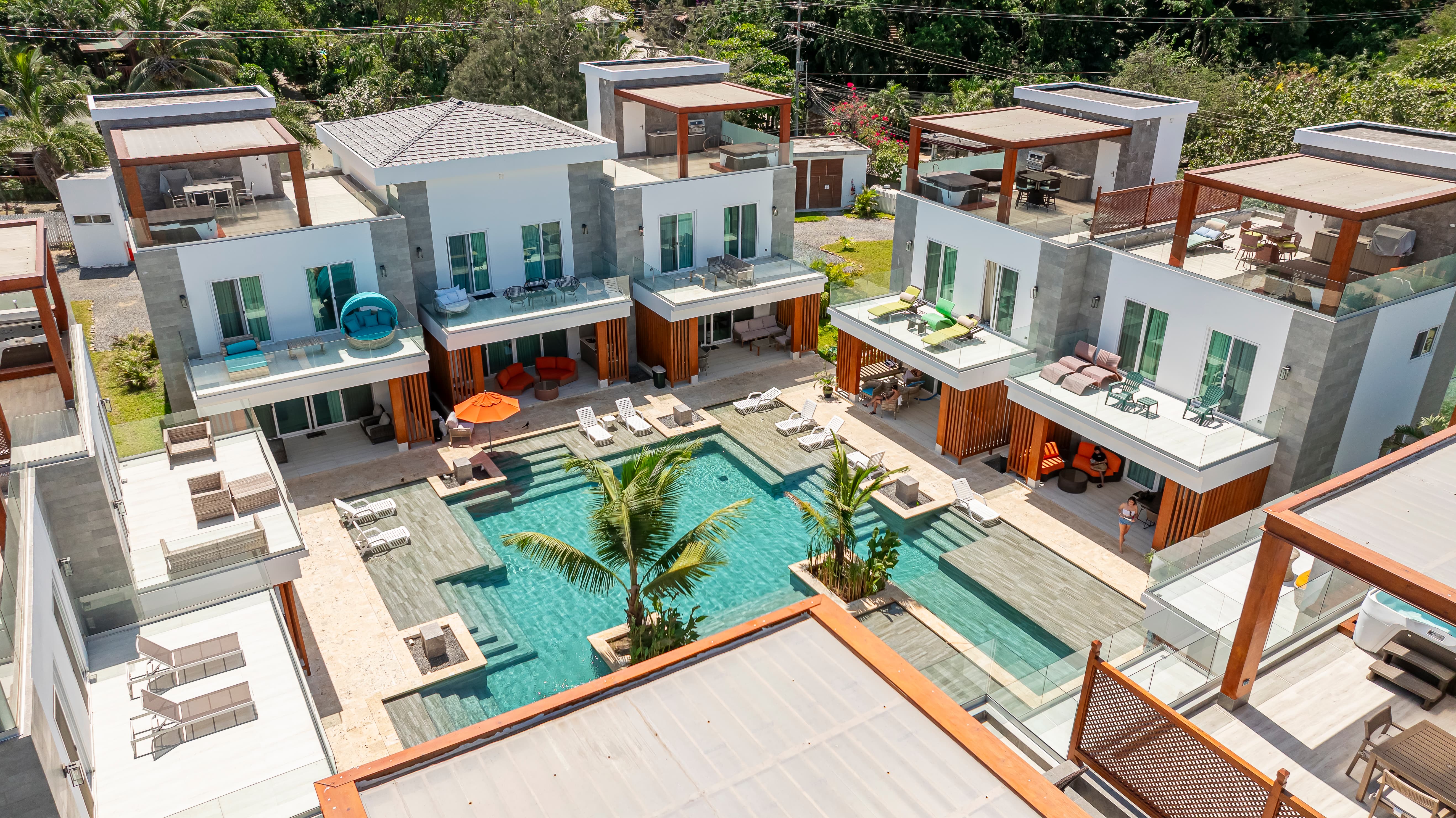 A poolside oasis featuring lounge chairs, perfect for a luxurious vacation at a modern villa